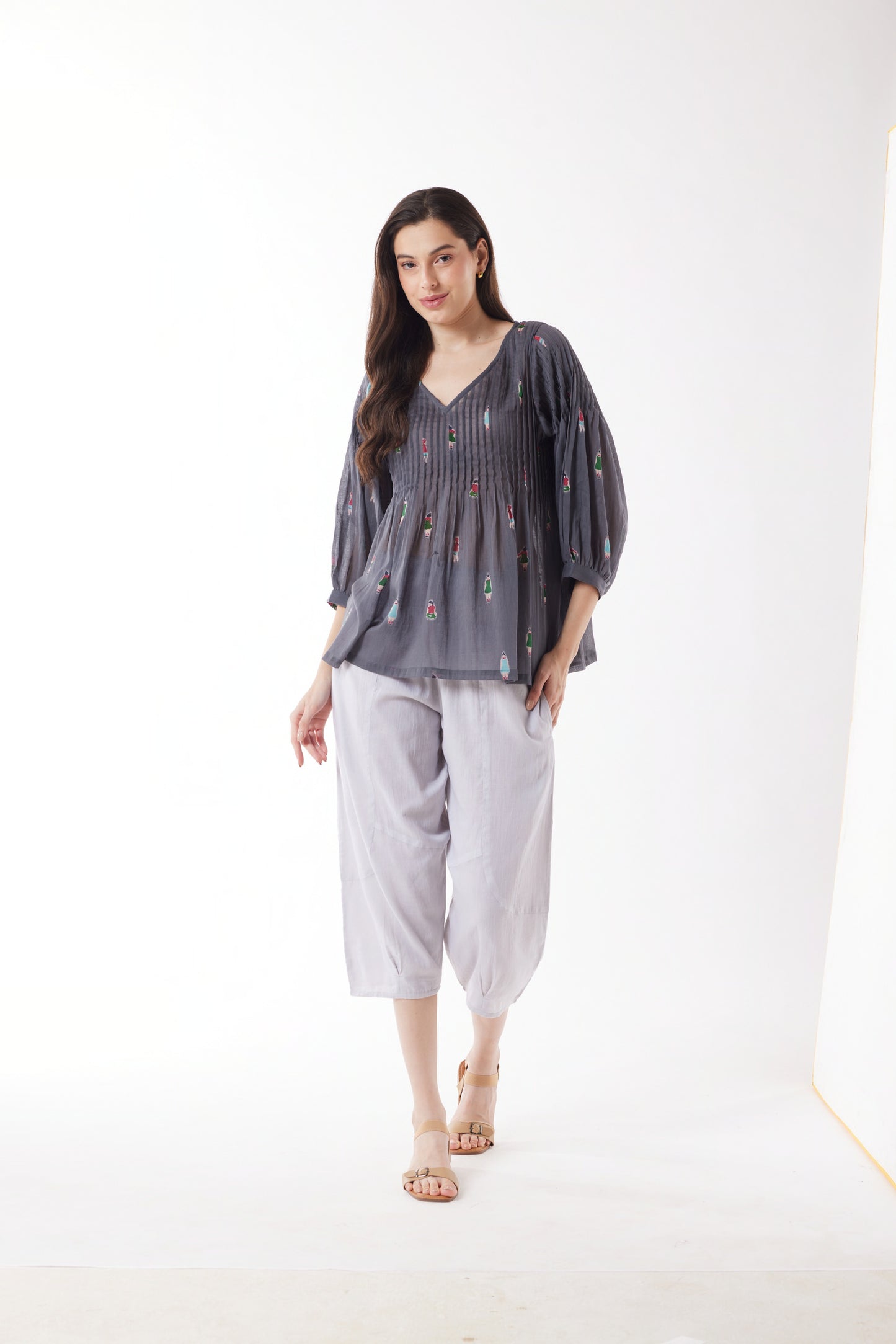 Woman wearing Au Hasard's D'Un Voyage's Pleated Top in People grey