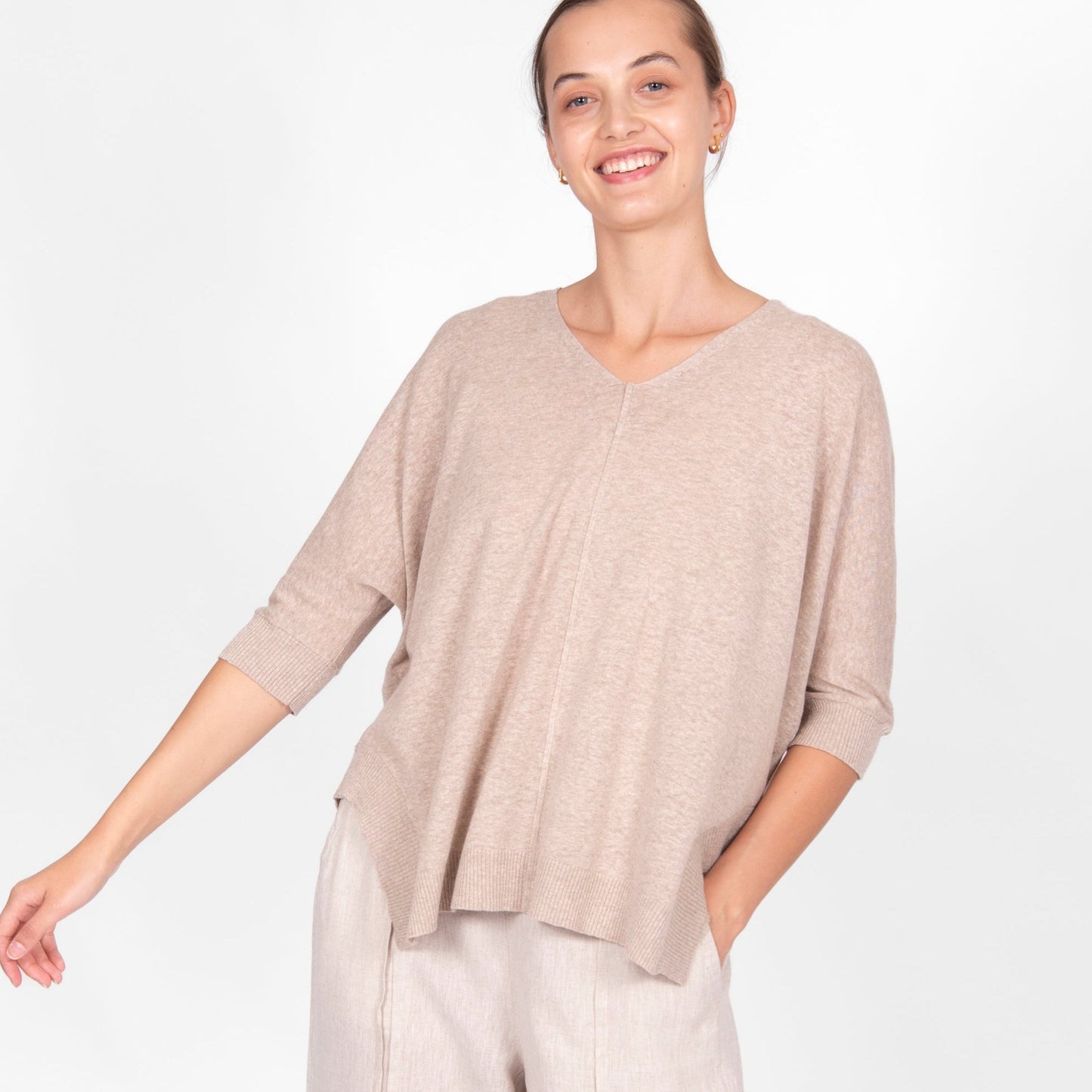 Woman wearing the cotton linen Swing top in oatmeal beige by Bridge and Lord