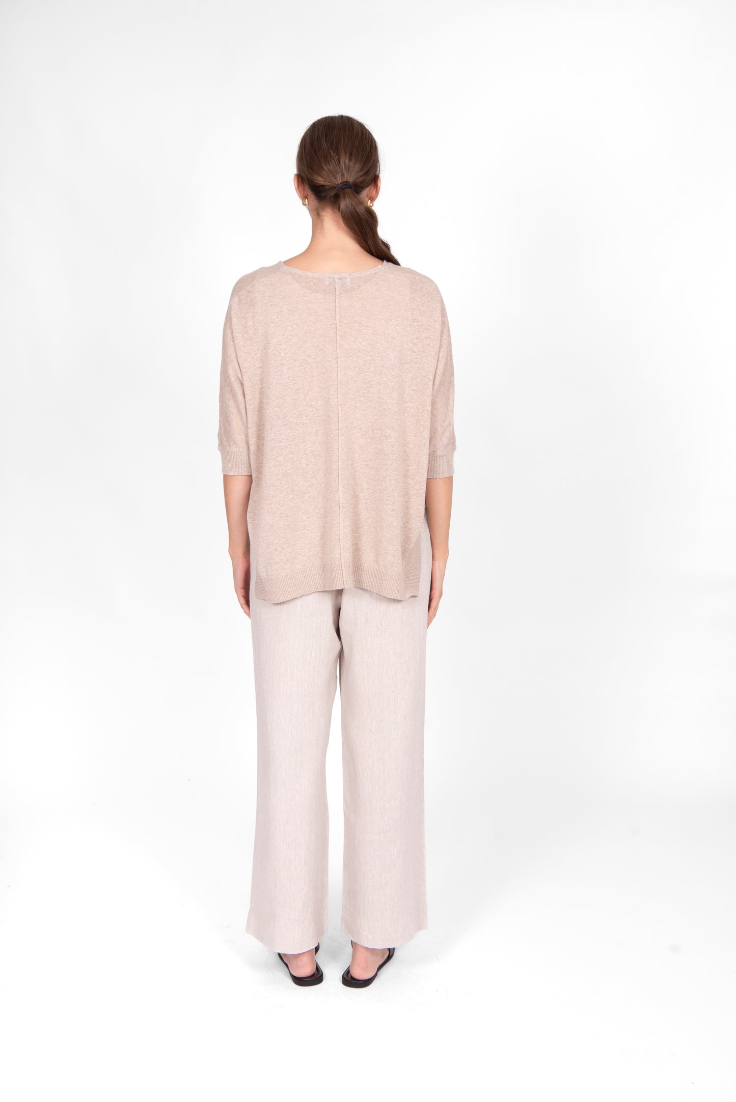 Woman wearing the cotton linen Swing top in oatmeal beige by Bridge and Lord