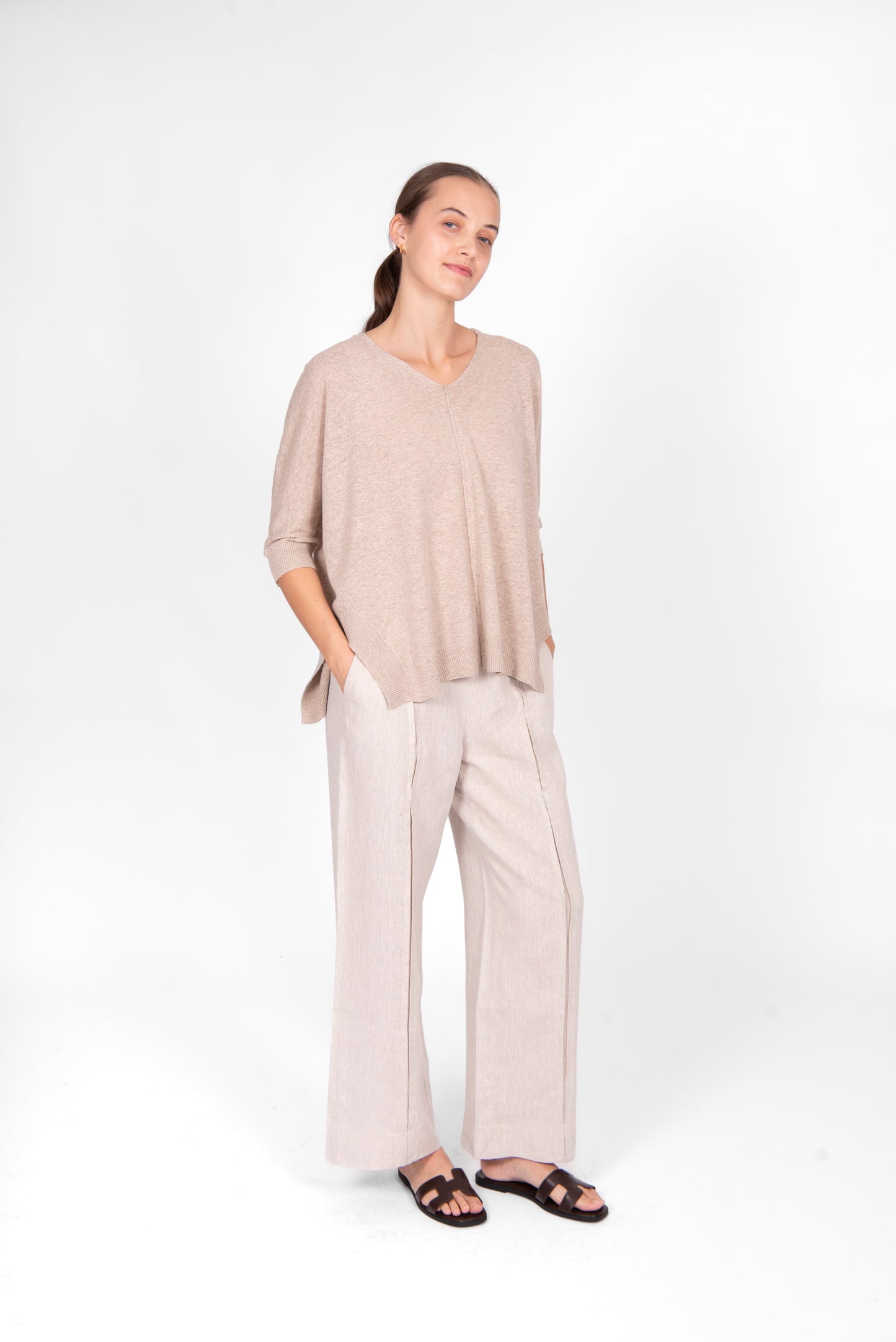 Woman wearing the cotton linen Swing top in oatmeal beige by Bridge and Lord
