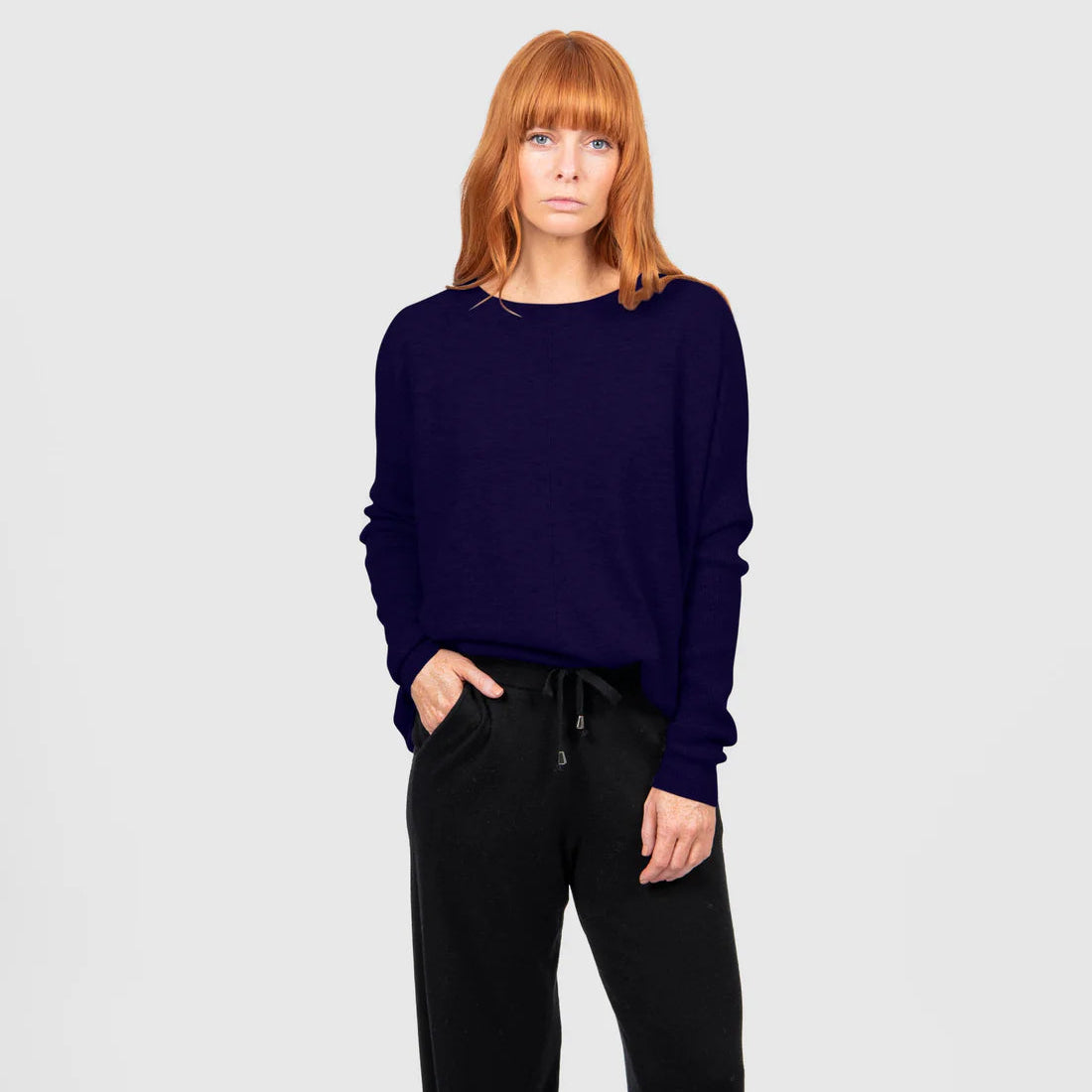 Woman wearing the Bridge and Lord Curved Hem Crew Neck Jumper in Carbon Blue
