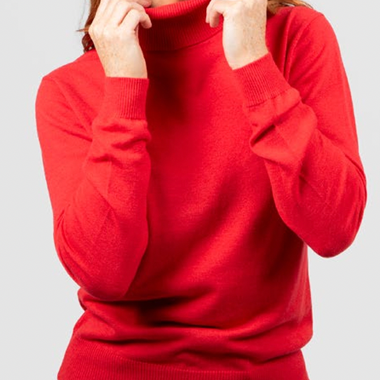 Woman wearing the Roll Neck Top in Cayenne by Bridge and Lord