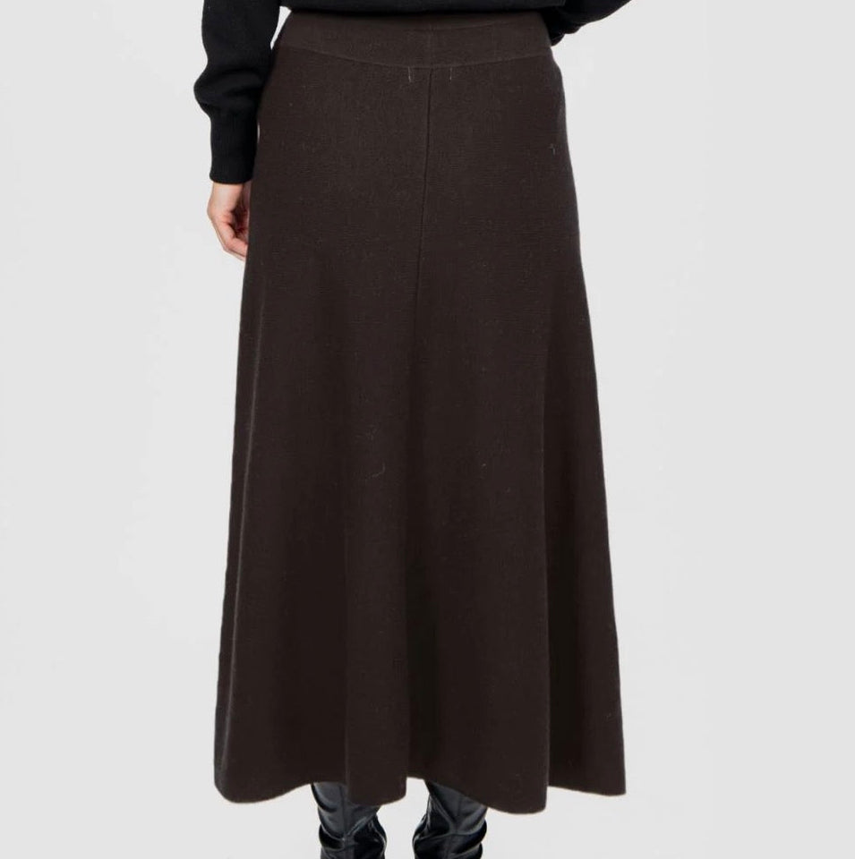 Back view of a w oman wearing the Flared Skirt in Chocolate by Bridge and Lord