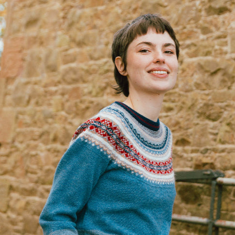 Woman wearing Eribé's Alpine Short Merino Sweater in Blue Morning