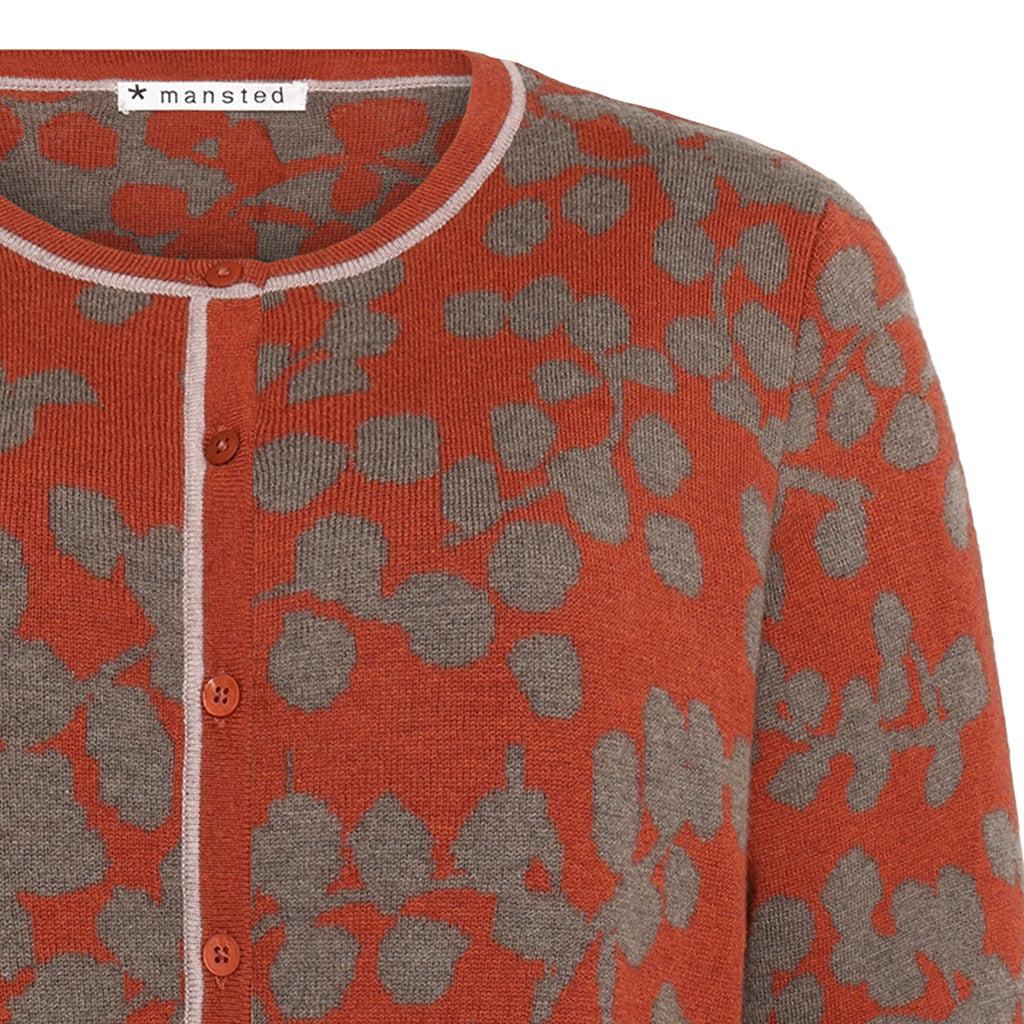 Detail of the floral Merino Natasha Cardigan in Rust red by Mansted