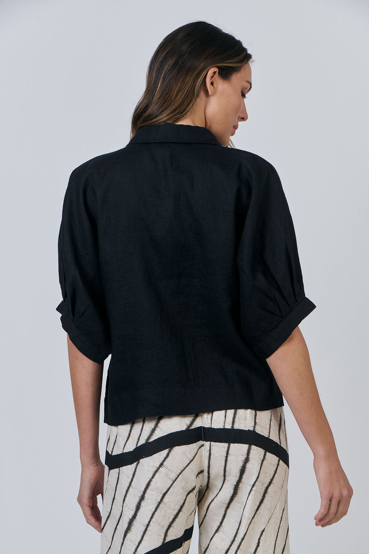 Woman wearing Naturals by O&J's 3/4 Sleeve Shirt in Black Linen