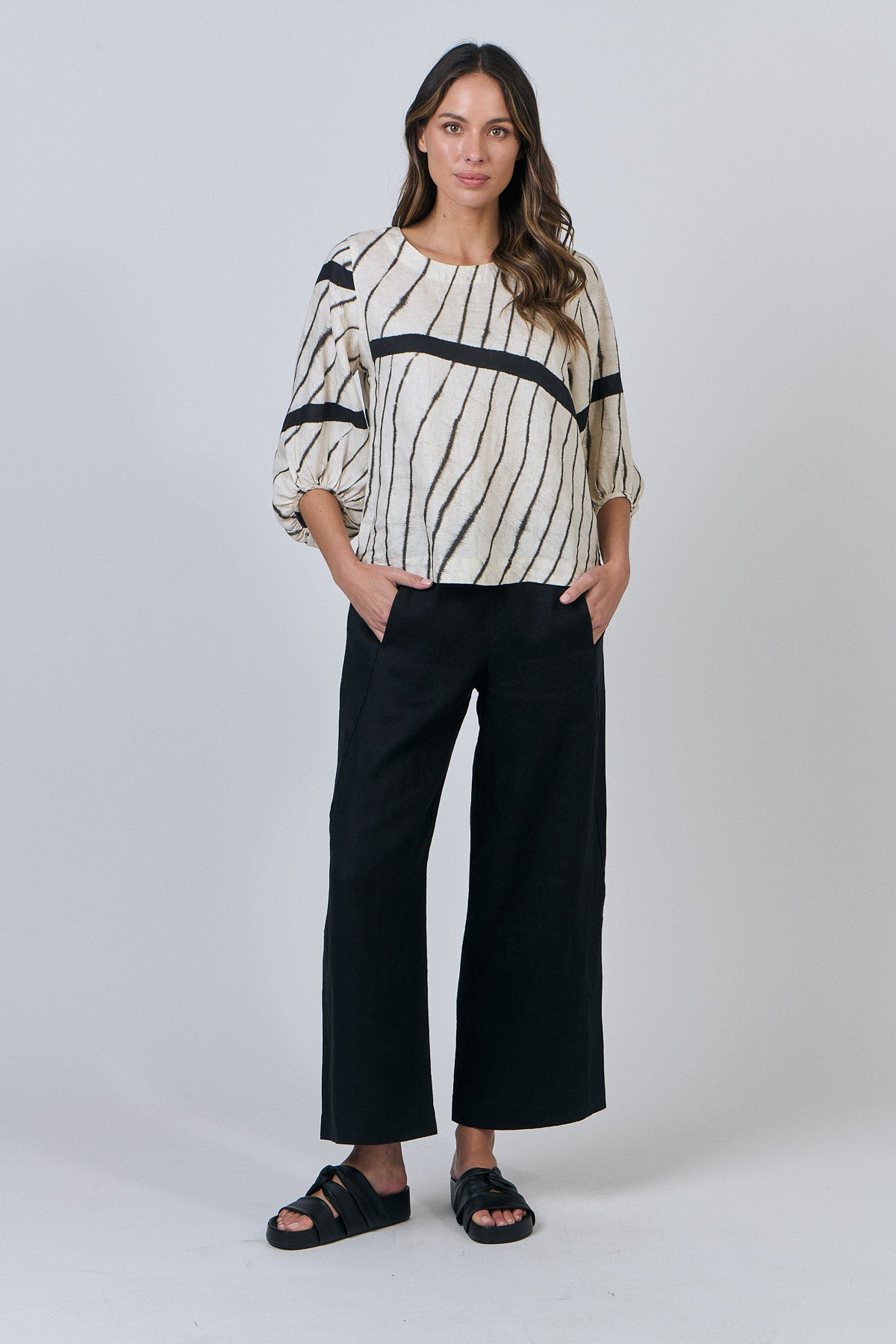 Woman wearing Natural by O&J's Bishop Sleeve linen Top in Isobars stripe
