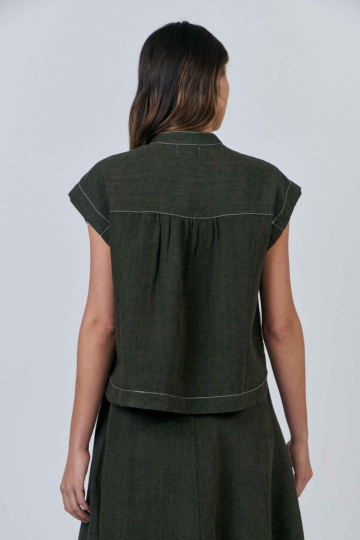 Woman wearing Naturals by O&J's Cap Sleeve linen Shirt in Licorice green