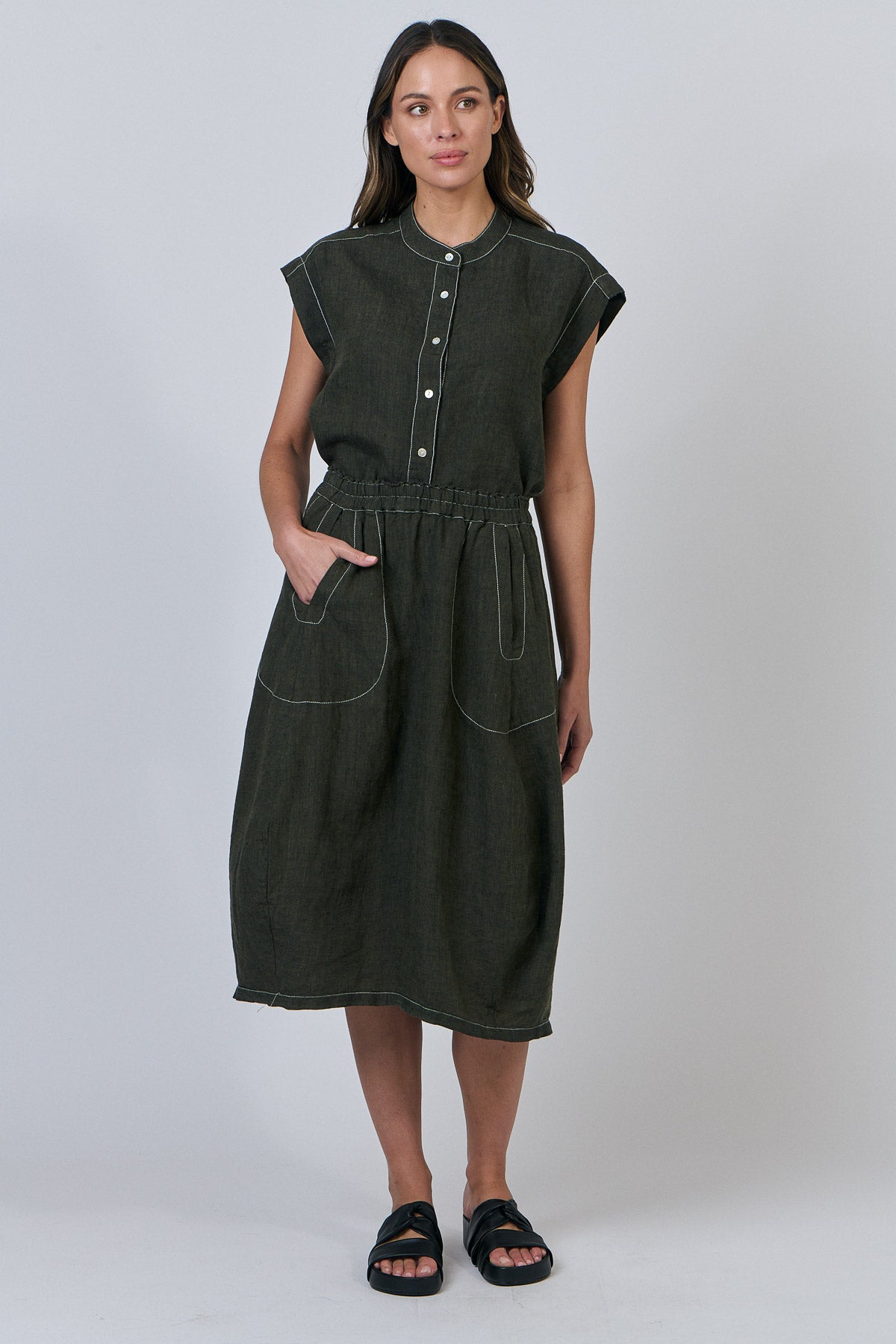 Woman wearing Naturals by O&J's Cap Sleeve linen Shirt in Licorice green