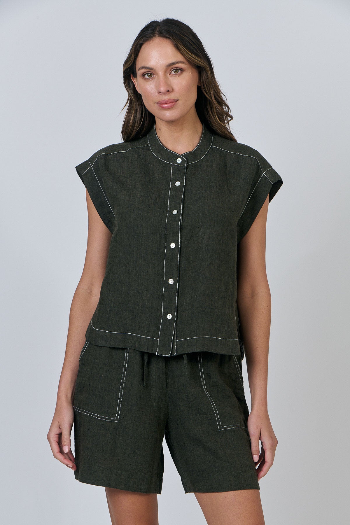 Woman wearing Naturals by O&J's Cap Sleeve linen Shirt in Licorice green