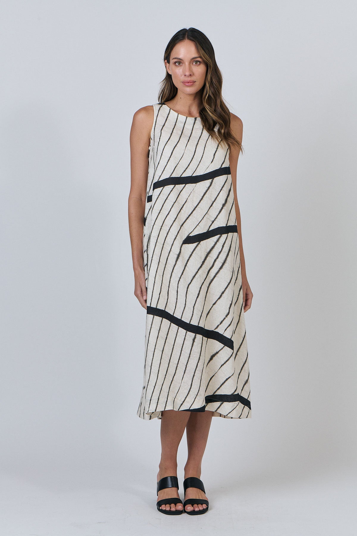 Woman wearing Naturals by O&J's Linen midi Dress in Isobars white