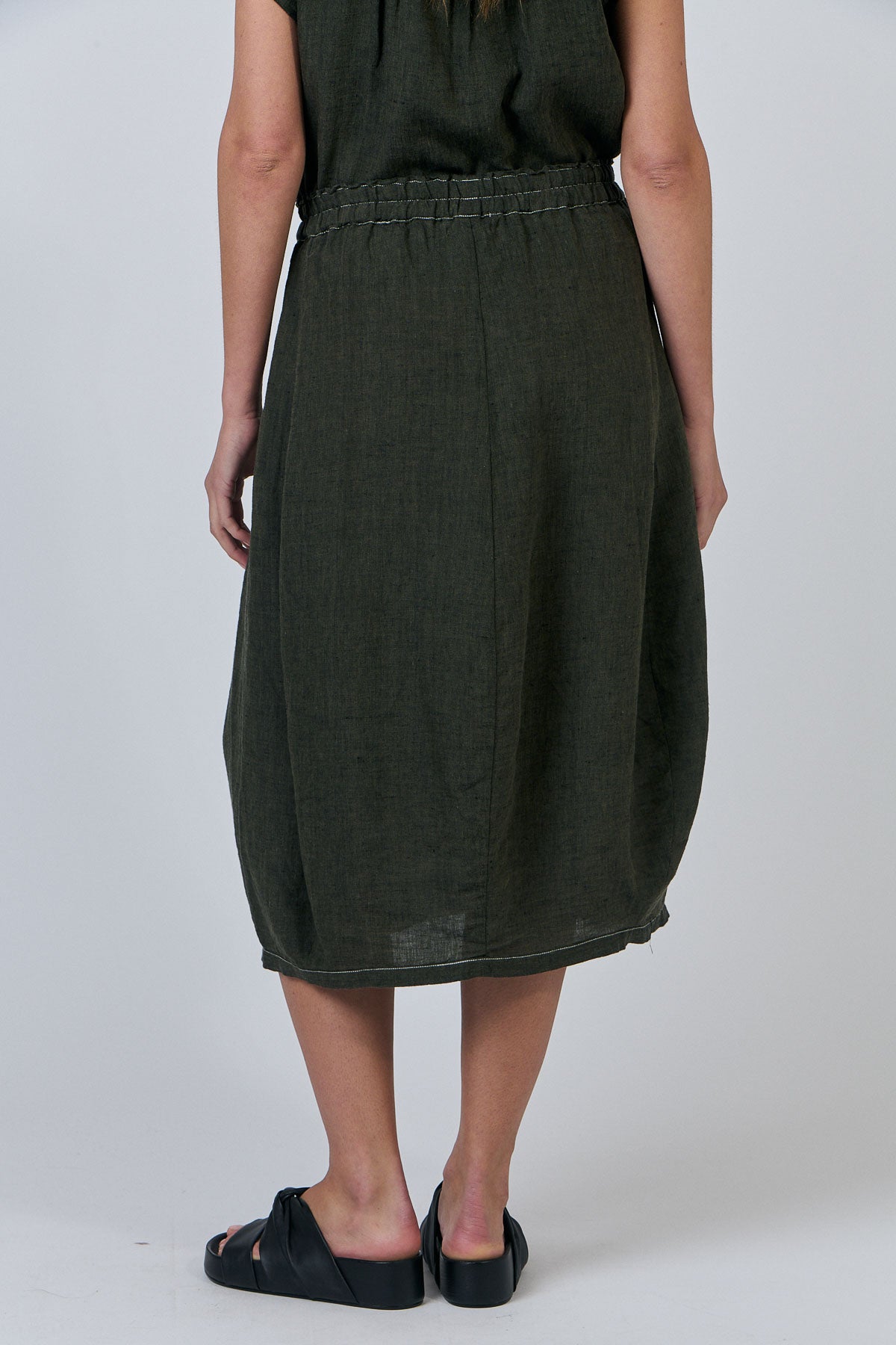 Woman wearing Naturals by O&J's linen Skirt in Licorice olive