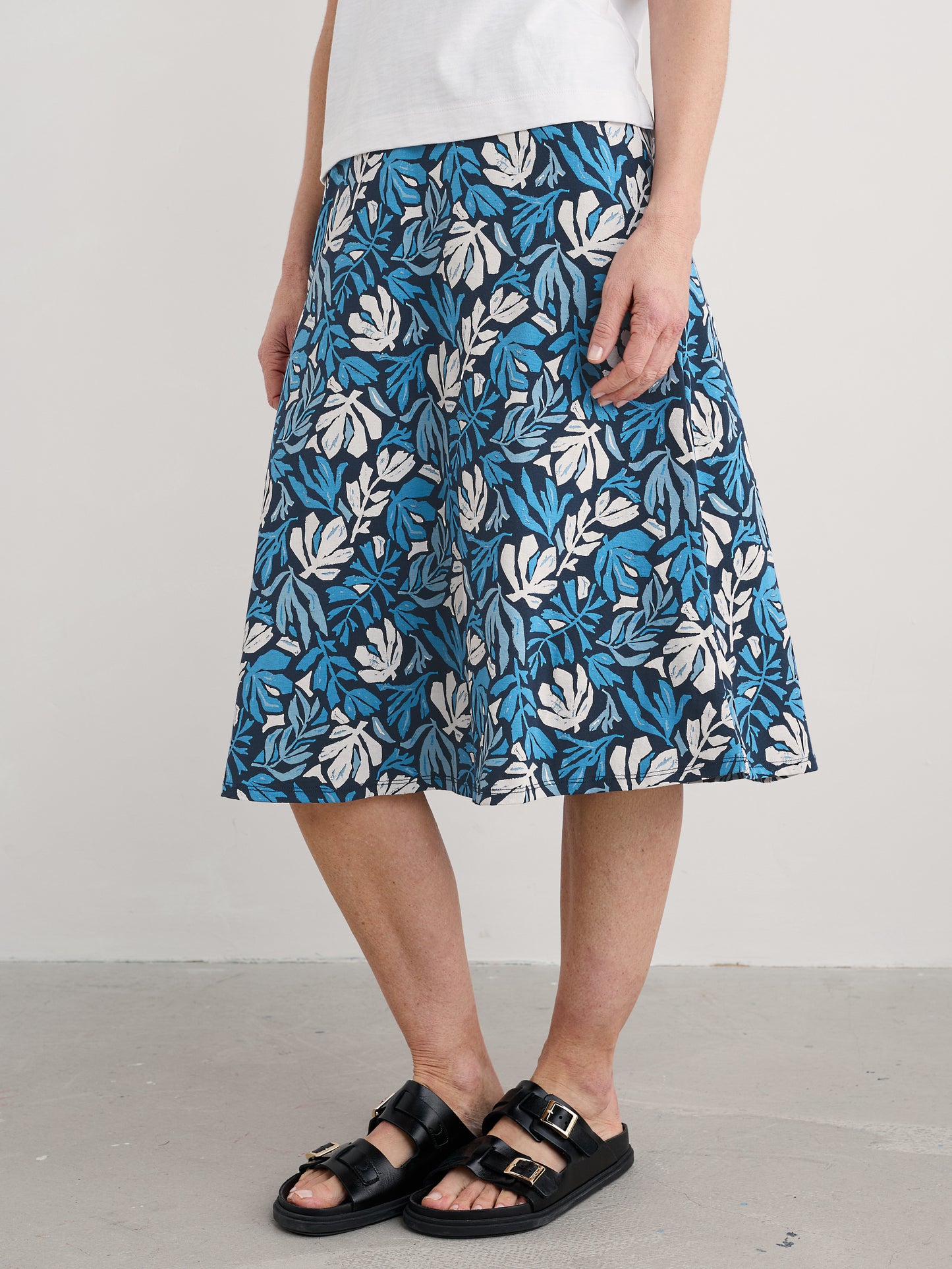 Woman wearing the Rose cotton midi Skirt by SEASALT in Cut Out Seaweed Maritime blue