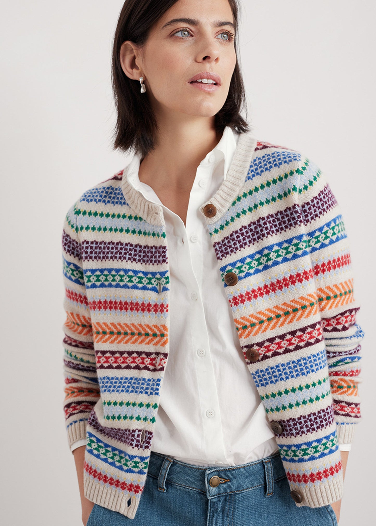 Woman wearing the Percella Cove wool cardigan by SEASALT in Abstraction Multi fair isle