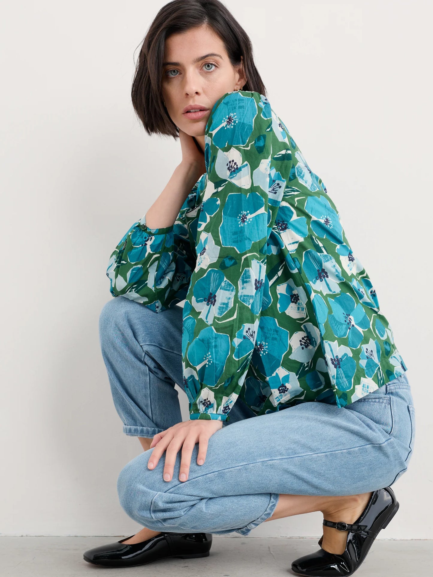 Woman wearing the Quill Blouse in Paper Hellebores Forest green by SEASALT