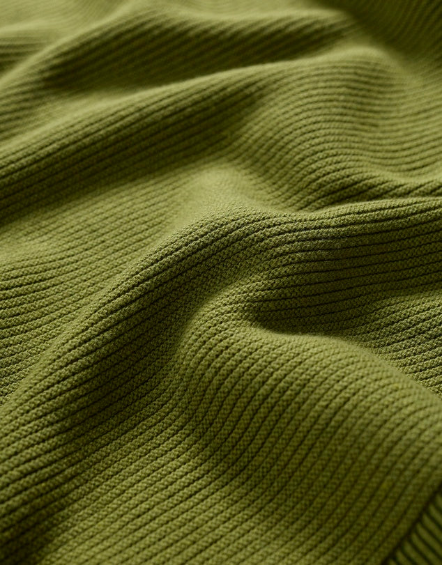 Close up of knitted cotton of the Makers Jumper in Dark Citron green