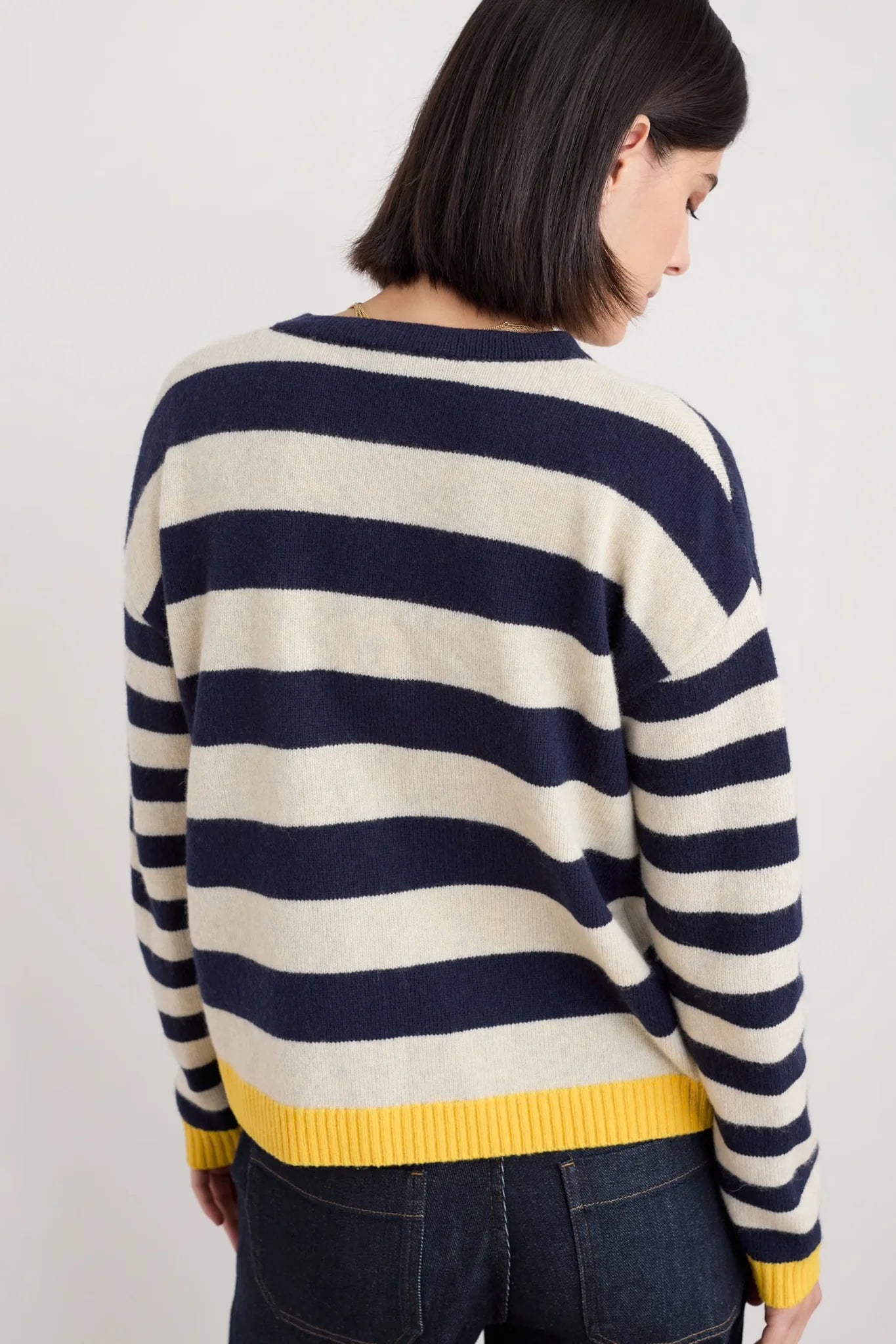 Back of Woman wearing the Pinwheel woollen Cardigan by SEASALT in Bright Shape Maritime Mix navy