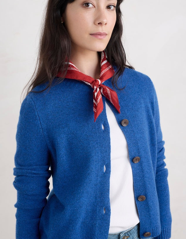 Woman wearing the Tern Tide merino wool Cardigan in Ink blue by SEASALT