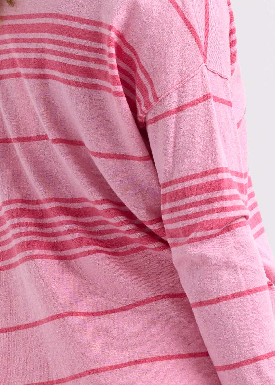 Woman wearing the Beach Bum stripey Jumper by Zaket and Plover in Fondant pink