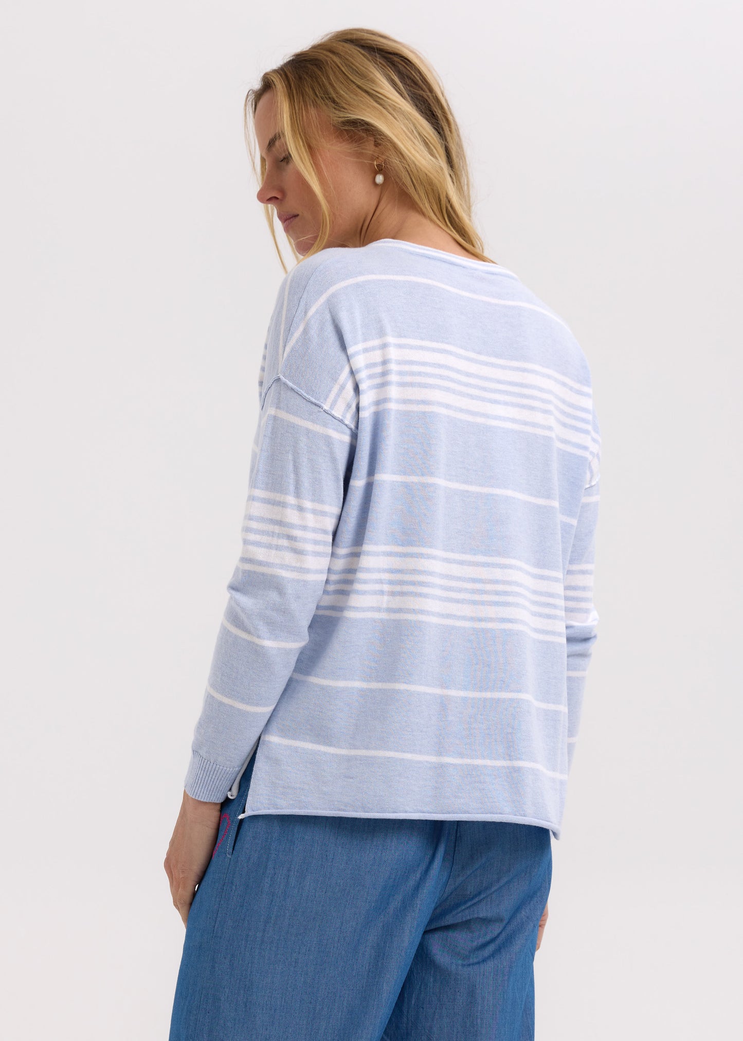 Woman wearing the Beach Bum stripey Jumper by Zaket and Plover in Powder blue