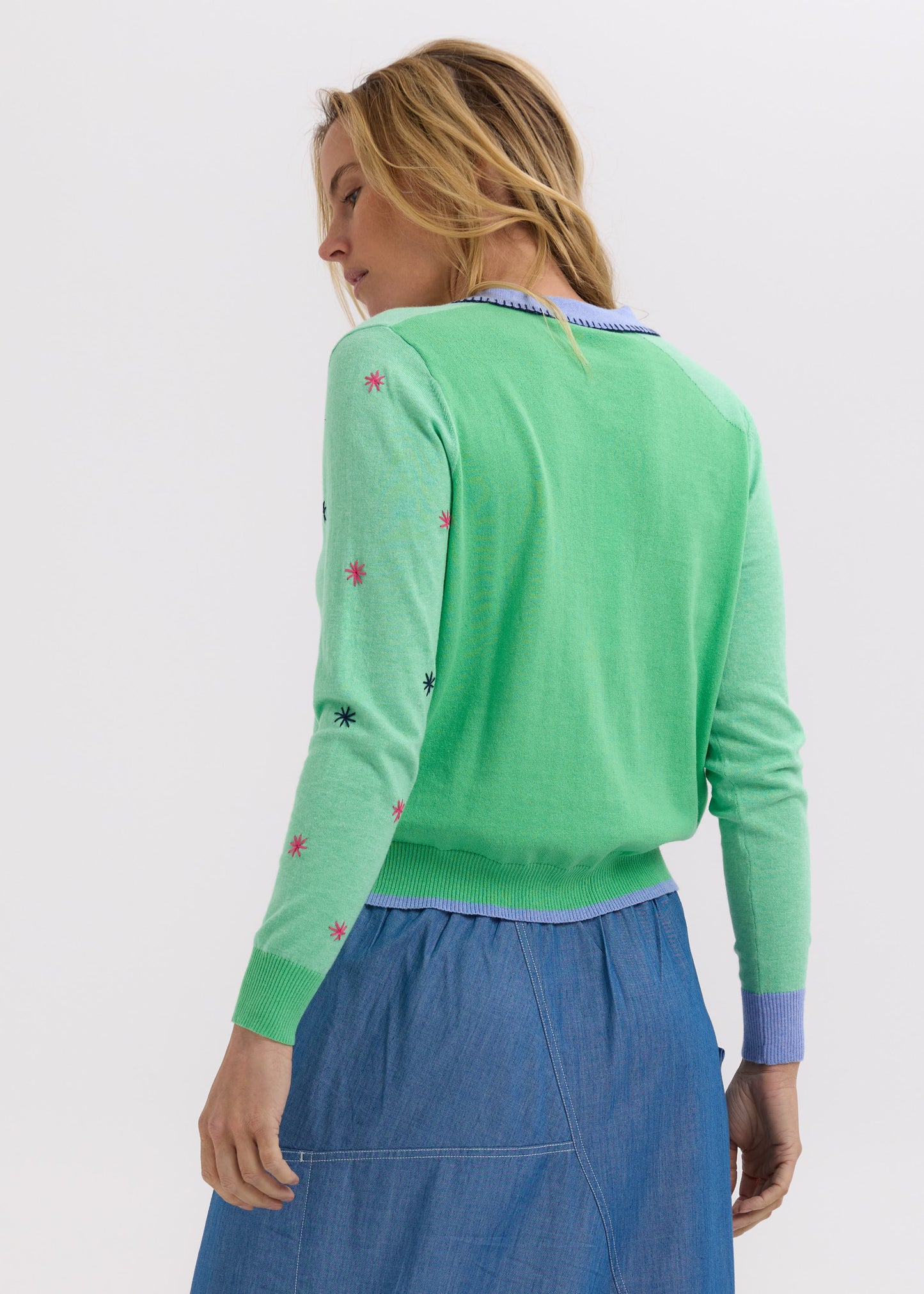Woman wearing the Blossoms Hand-Work Cardigan by Zaket and Plover in Spearmint green