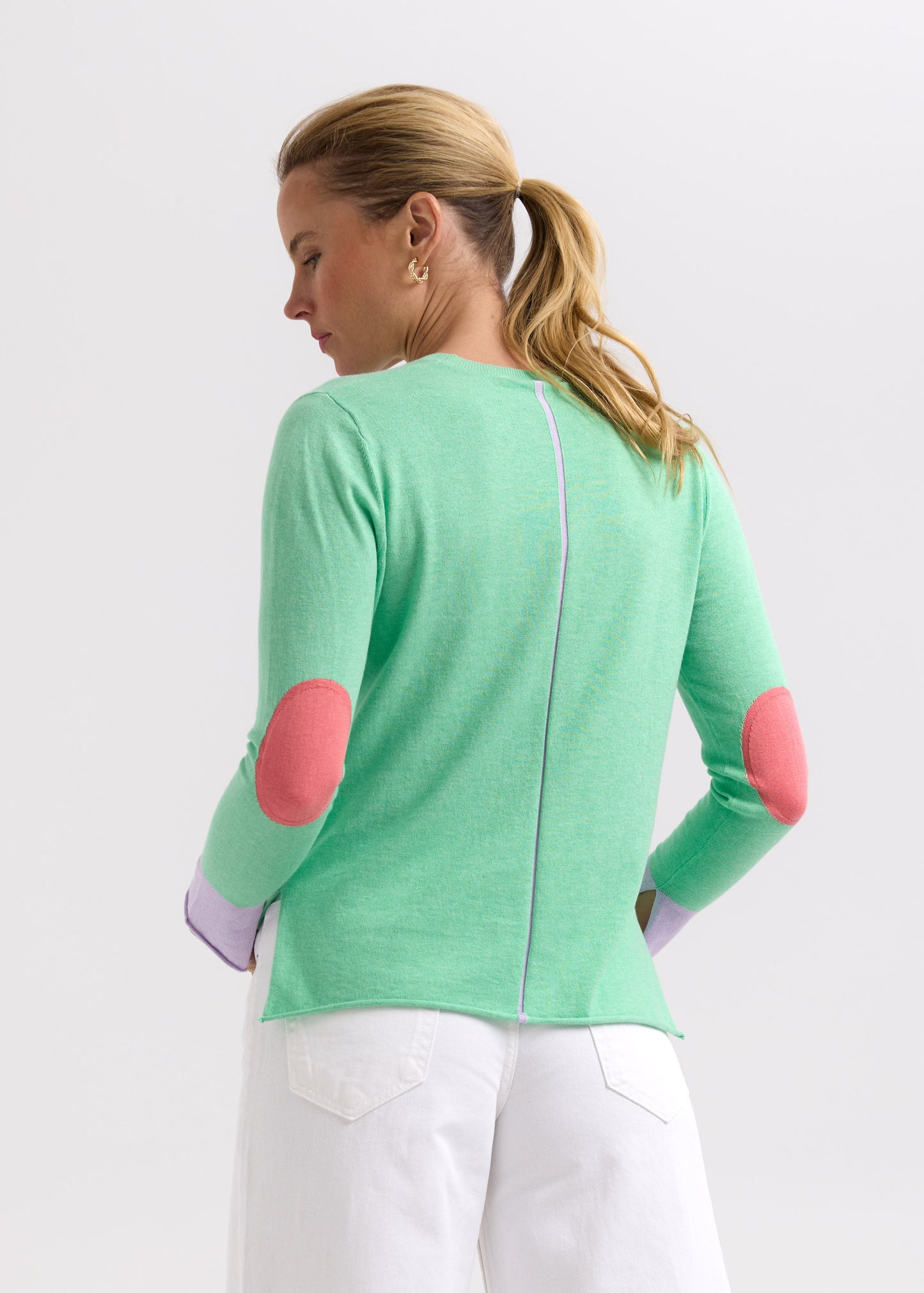 Woman wearing the Elbow Patch Jumper by Zaket and Plover in Spearmint green