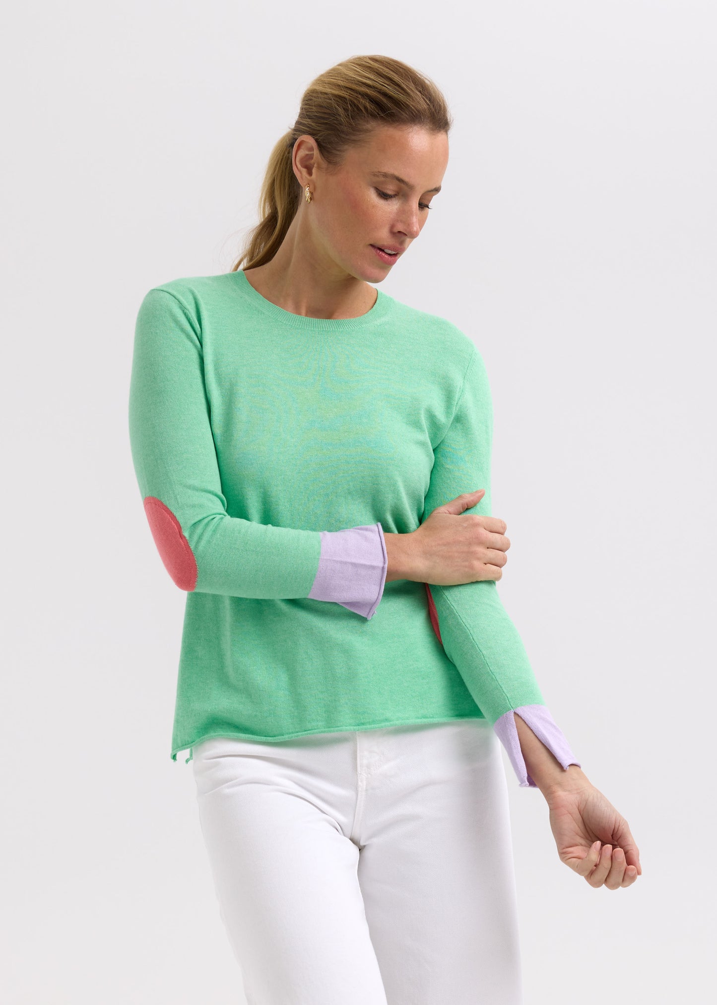 Woman wearing the Elbow Patch Jumper by Zaket and Plover in Spearmint green