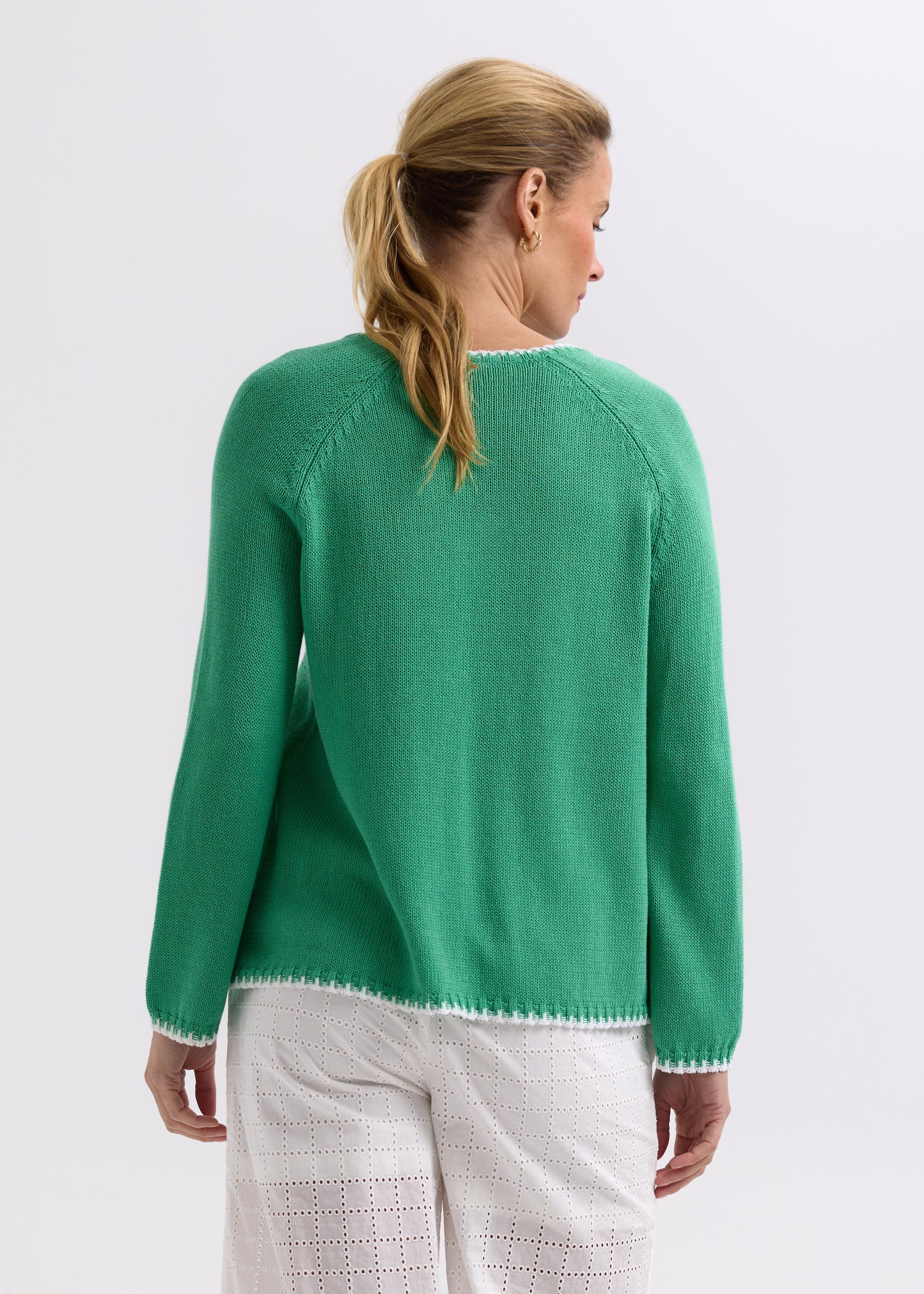 Woman wearing the Hand Work Trim Sweater in green Apple by Zaket and Plover