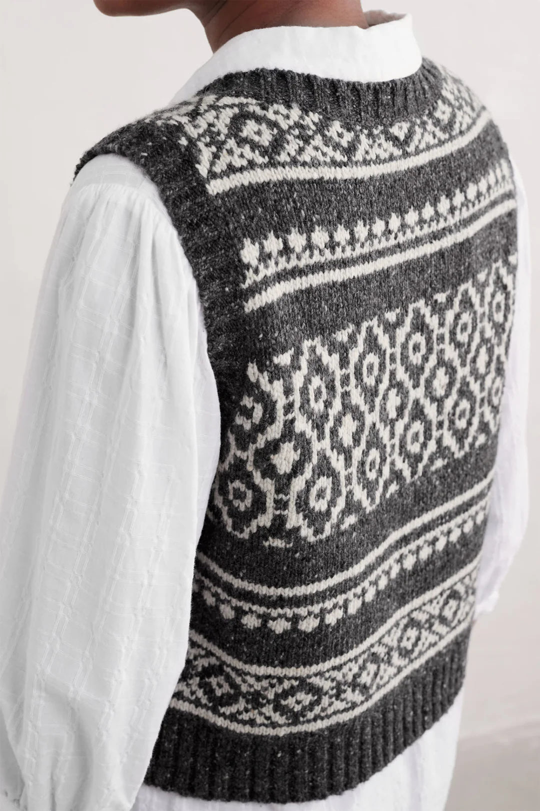 Back view of SEASALT's Castwork Fair Isle Vest in Shingle Bar Onyx Aran