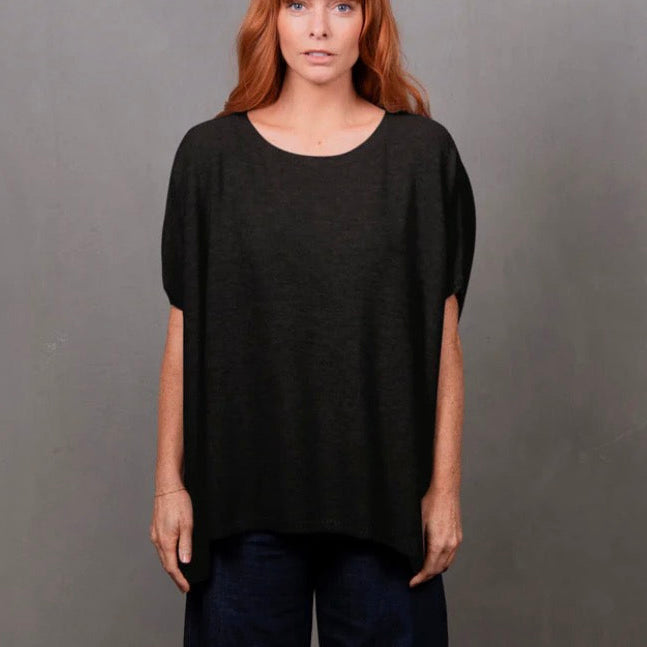 Woman wearing the Bridge and Lord seed stitch black poncho
