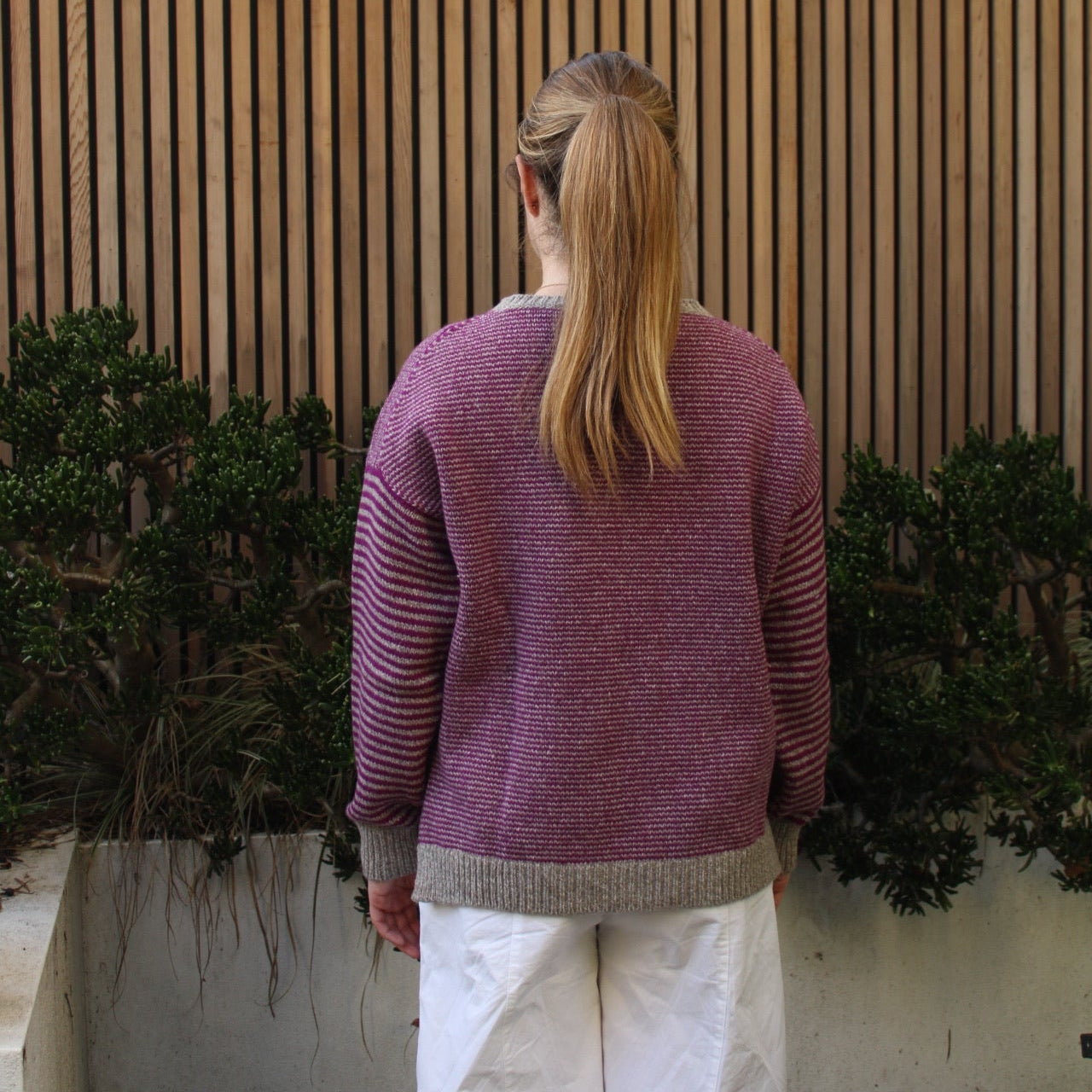 Woman wearing the Fisherman Out Of Ireland Striped Crew Jumper in Mushroom and Foxglove