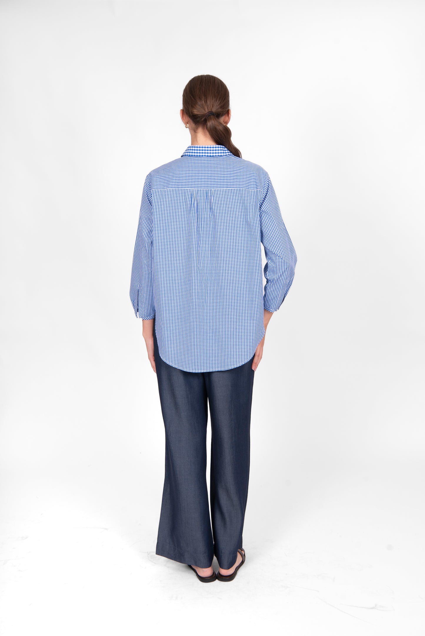Woman wearing the cotton gingham shirt by bridge and lord in cobalt blue