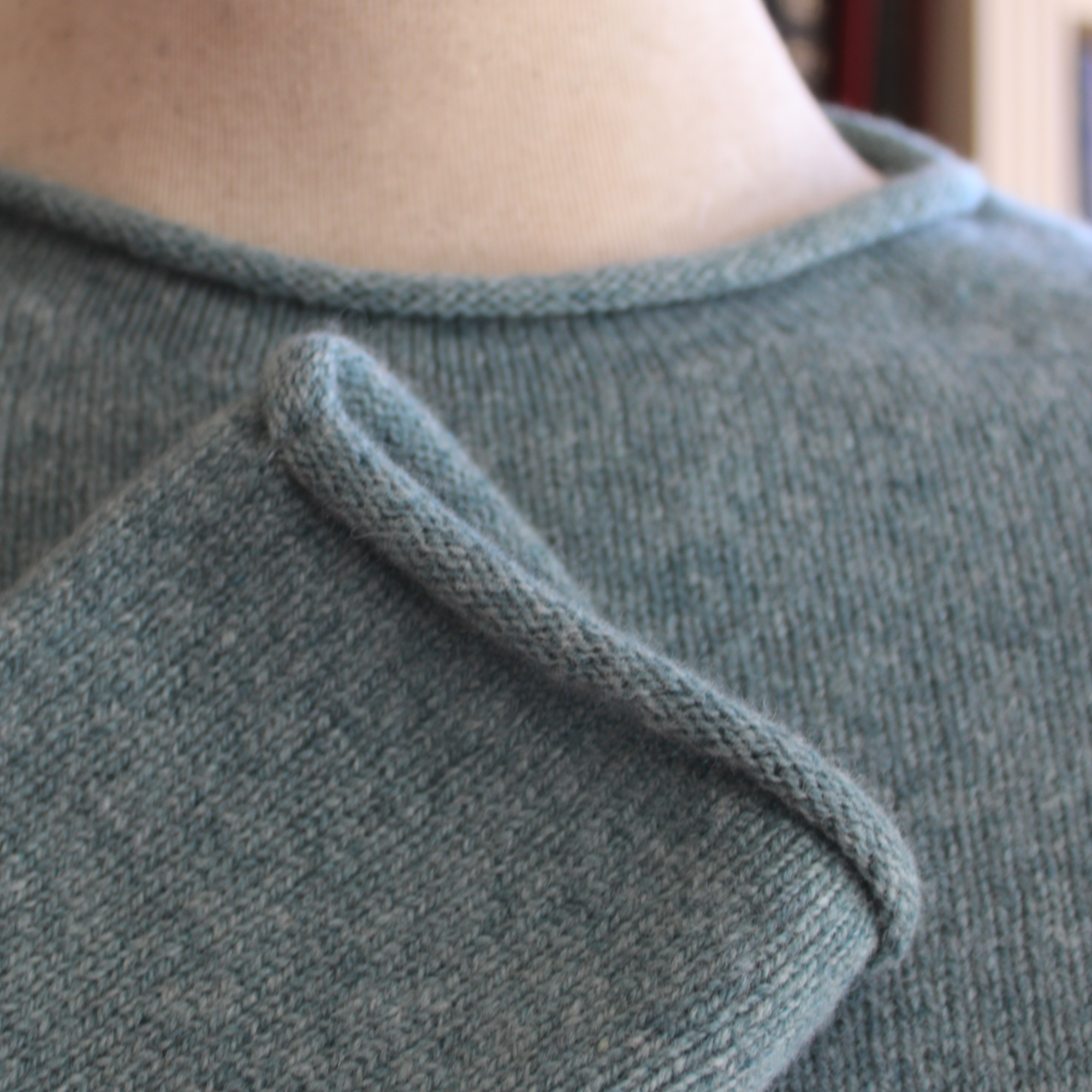 A premium grade merino lambs wool jumper from Harley of Scotland. In Oribe green it has a crew nwck and small rolls on the cuffs hem and neck. Beautiful Scottish Knitwear