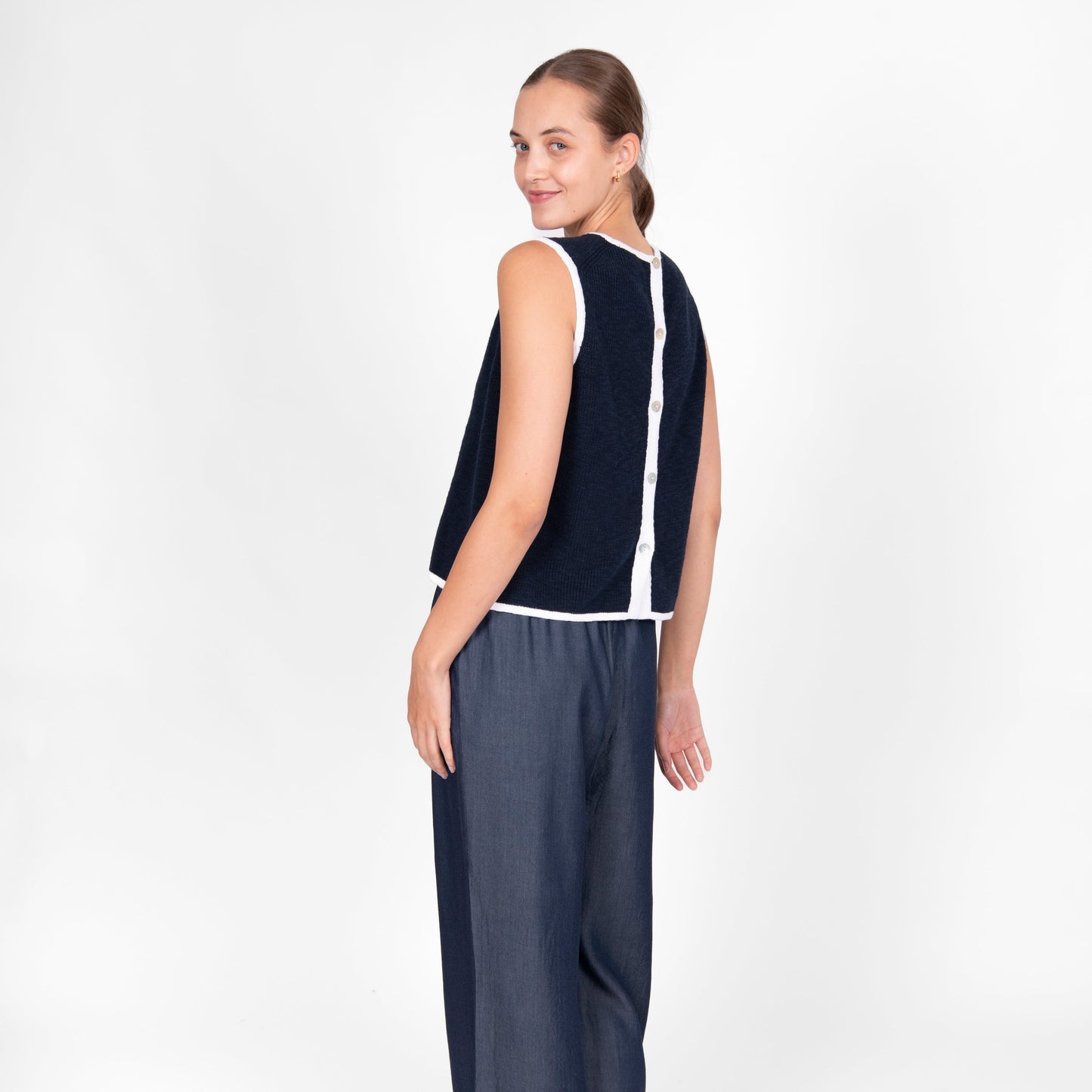 Woman wearing the cotton linen Button Back Vest top in navy white by Bridge and Lord