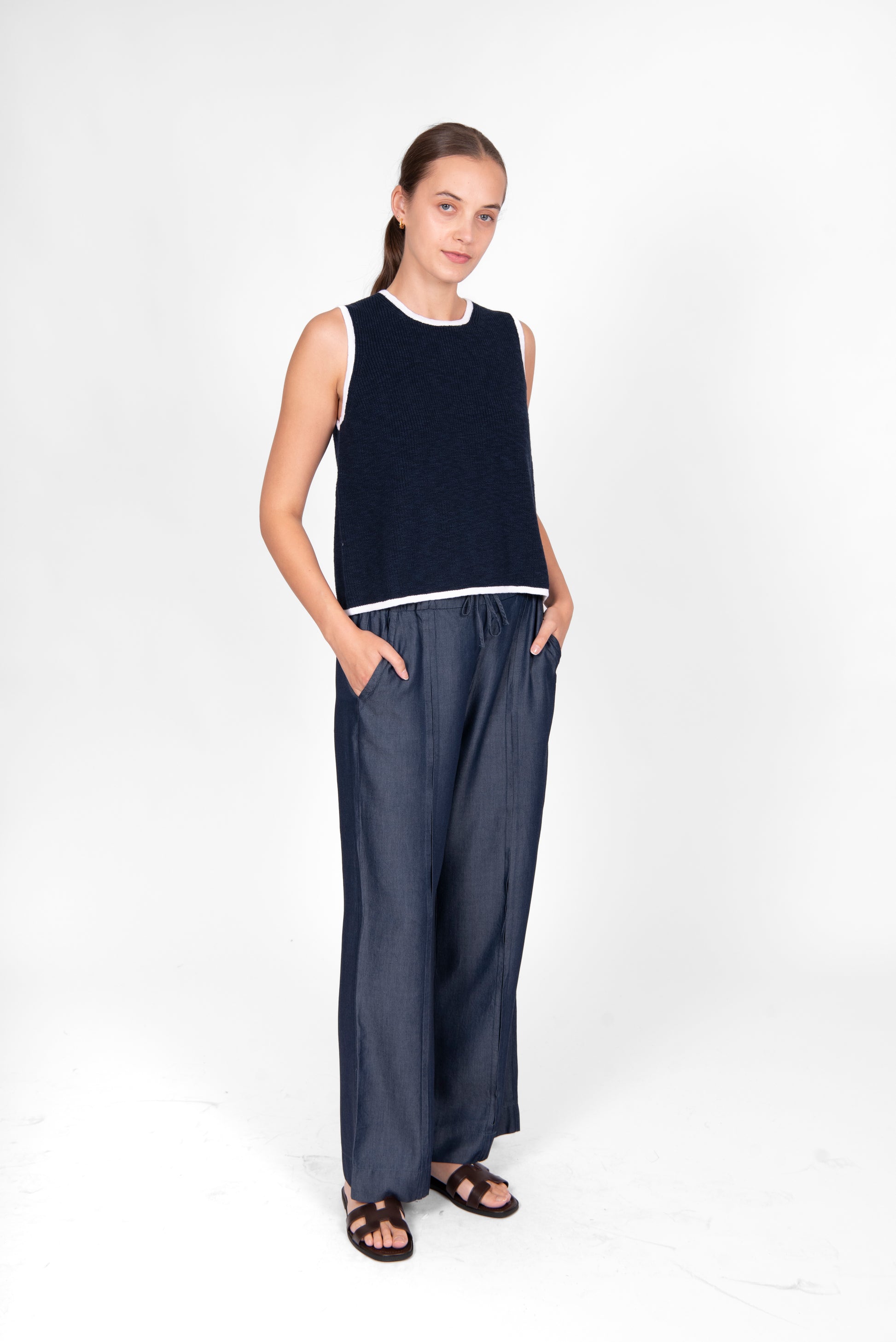 Woman wearing the cotton linen Button Back Vest top in navy white by Bridge and Lord