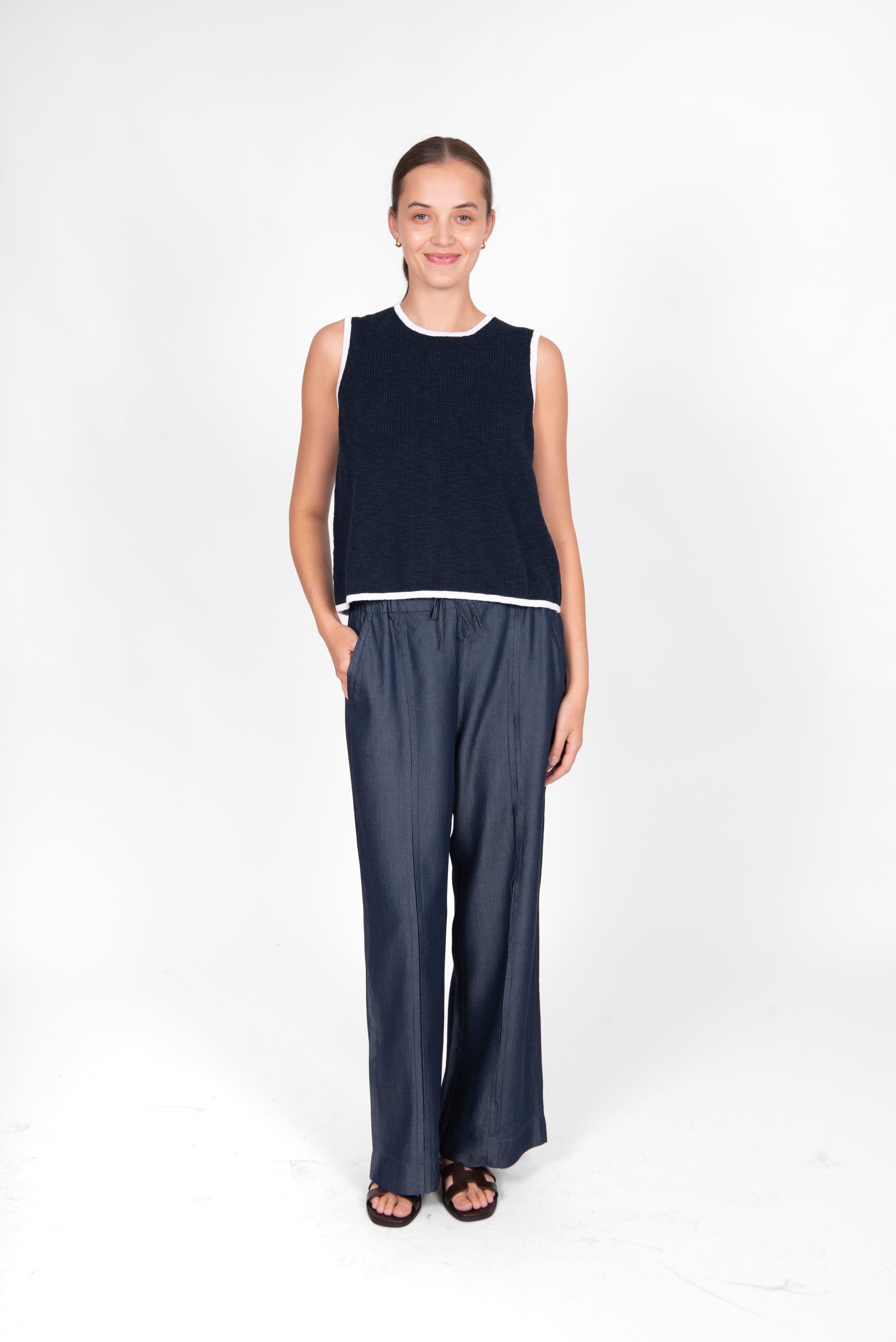 Woman wearing the cotton linen Button Back Vest top in navy white by Bridge and Lord
