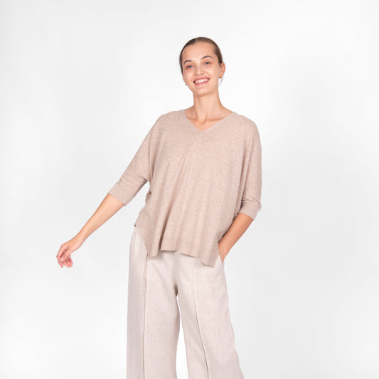 Woman wearing the cotton linen Swing top in oatmeal beige by Bridge and Lord