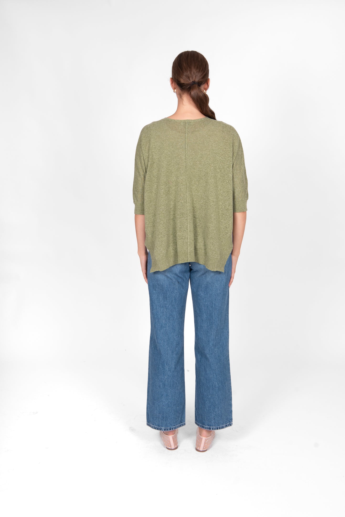 Woman wearing the Bridge and Lord cotton linen swing top in sage green