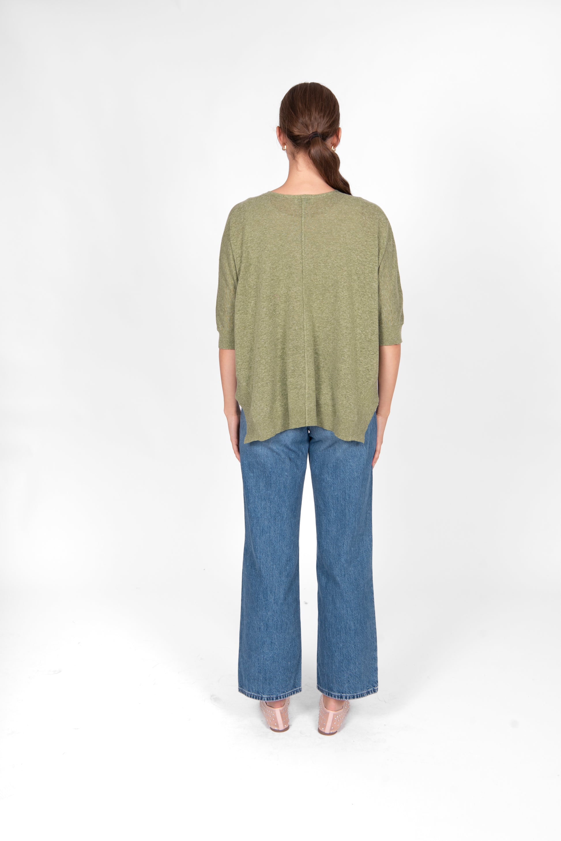 Woman wearing the Bridge and Lord cotton linen swing top in sage green
