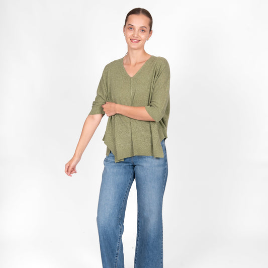 Woman wearing the Bridge and Lord cotton linen swing top in sage green