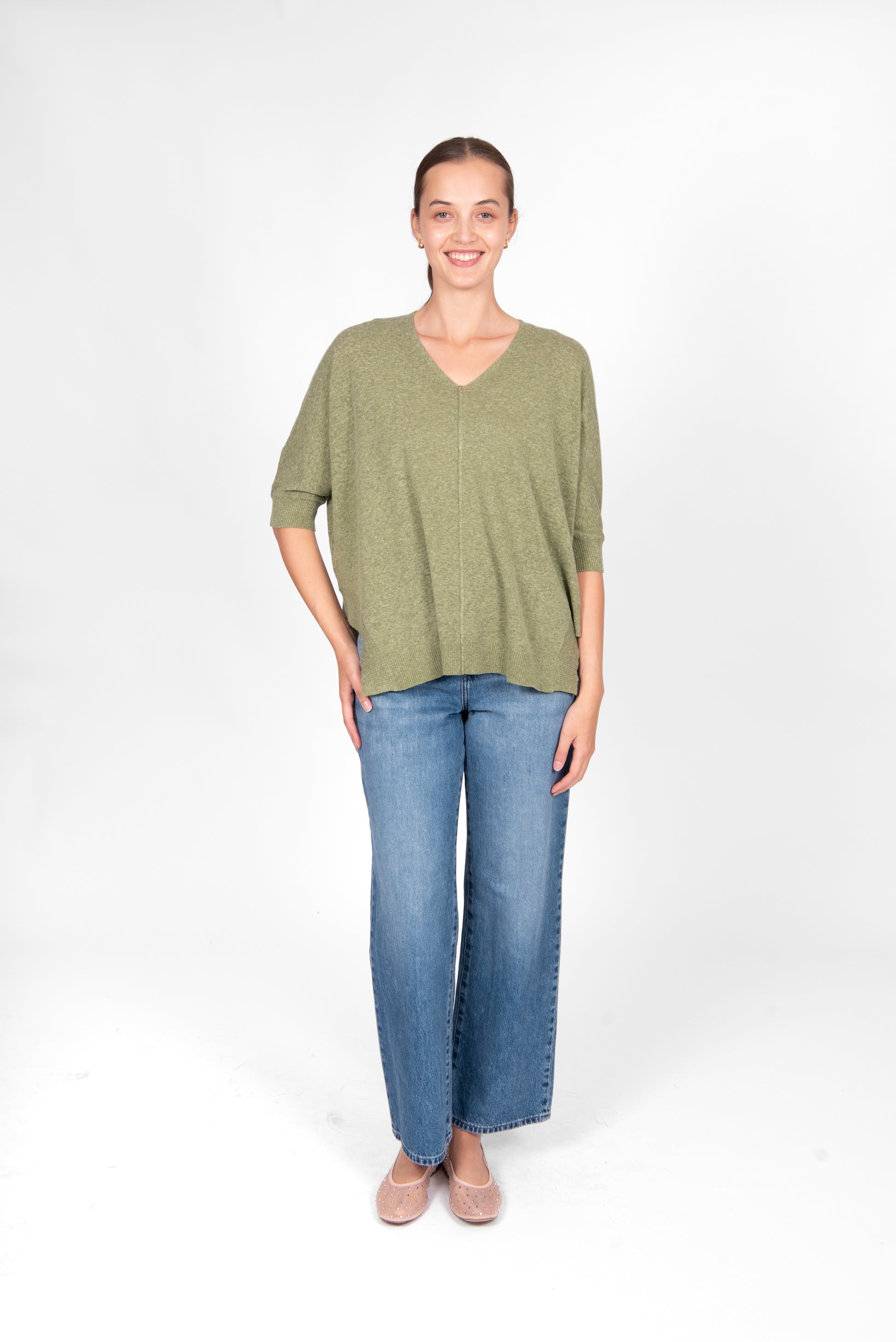 Woman wearing the Bridge and Lord cotton linen swing top in sage green