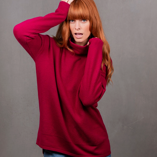 Woman wears the Ball Stitch High Crew Jumper by Bridge and Lord in Cassis red