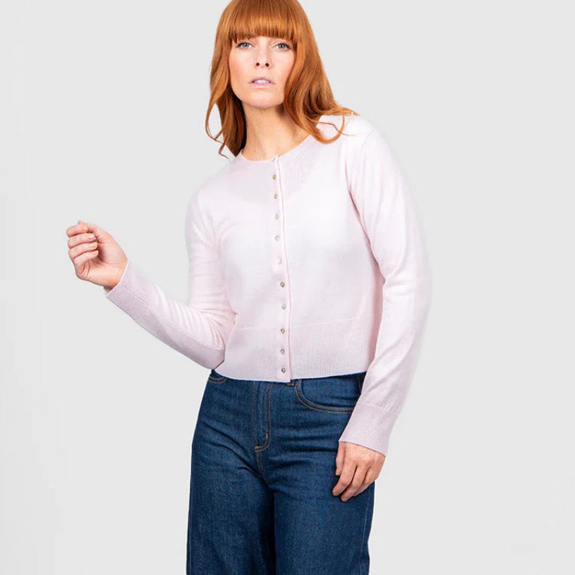Woman wearing a pink cropped cardigan by Bridge and Lord