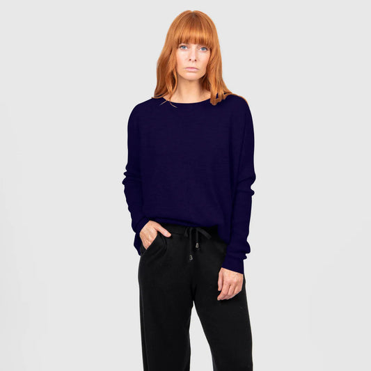 Woman wearing the Bridge and Lord Curved Hem Crew Neck Jumper in Carbon Blue
