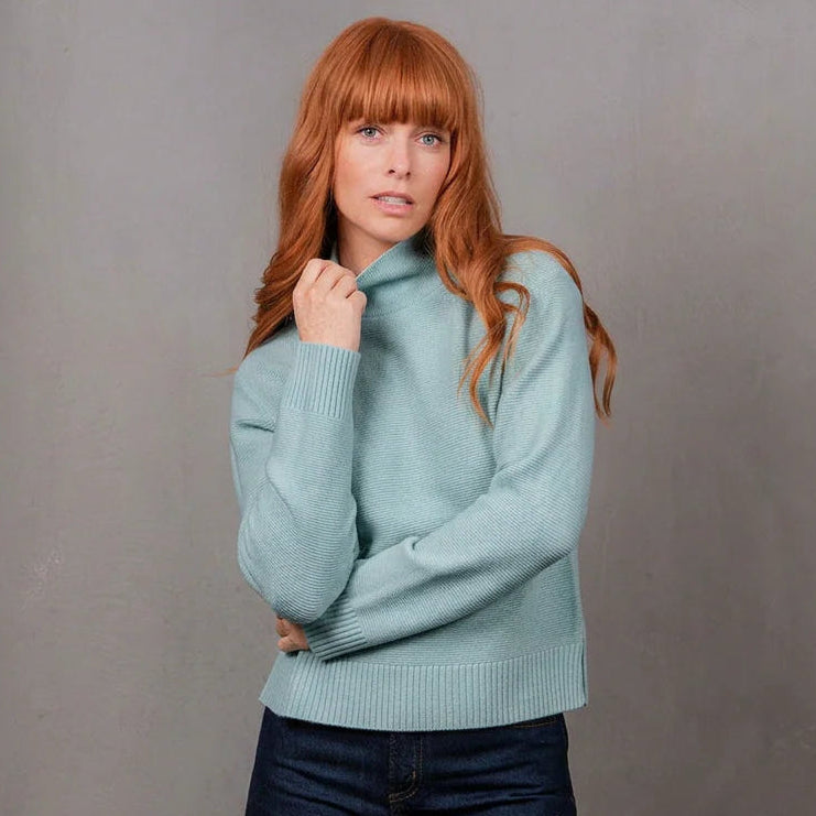Woman wearing the Bridge and Lord Links Ribbed merino Pullover in Aquamarine blue