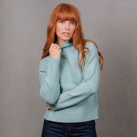 Woman wearing the Bridge and Lord Links Ribbed merino Pullover in Aquamarine blue