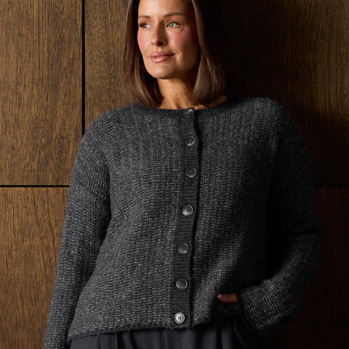 Woman wearing the Merino links stripe grey cardigan by Bridge and Lord