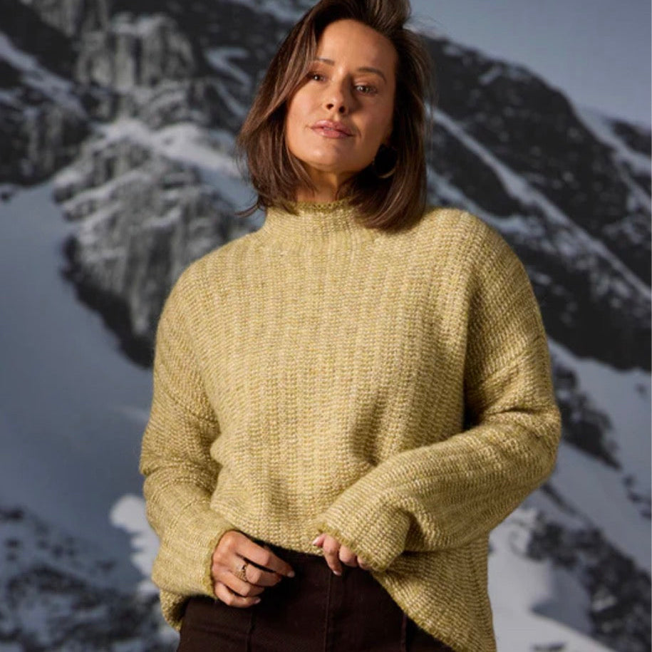 Woman wearing the Links stripe yellow pullover by Bridge and Lord in citrine
