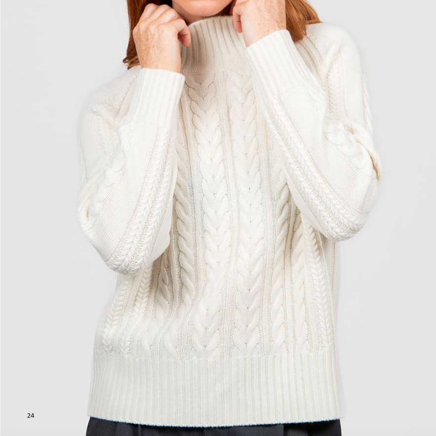 Woman wearing the Cable Raglan Jumper by Bridge and Lord in ivory white