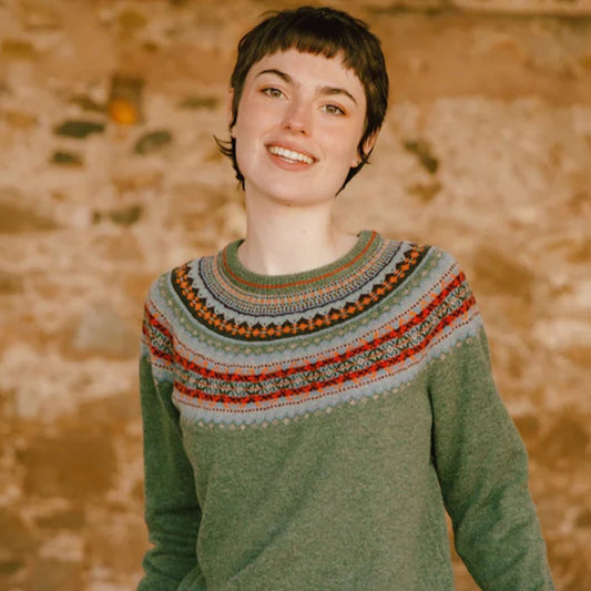 Woman wearing Eribé's Fair Isle Alpine Short Sweater in green Braemar